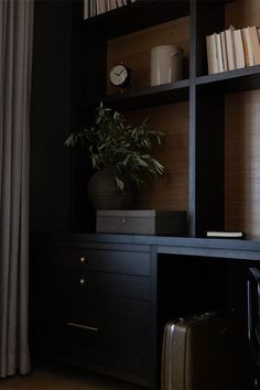 Moody office with dark cabinetry, custom built-ins, decor accents and inspirational details. Wood Built Ins