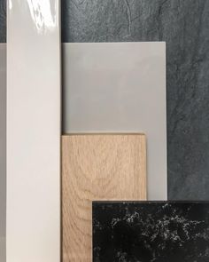 several different types of wood and tile are shown in this image, including white, gray, and black