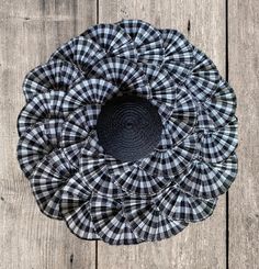 a black and white checkered hat sitting on top of a wooden floor