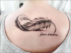 a woman's back shoulder with a feather and the words follow your dreams on it