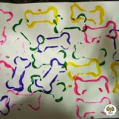 a paper with colored dog shapes on it