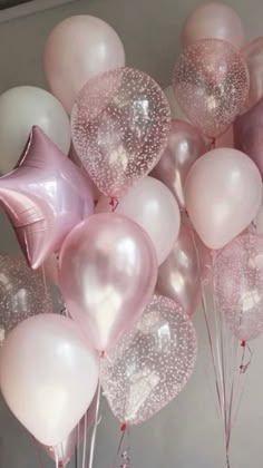 a bunch of pink and white balloons in the shape of heart - shaped balloons with glitter on them