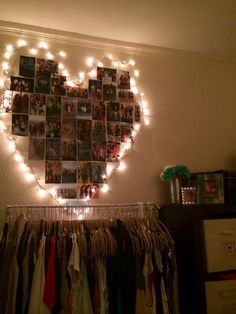 a heart shaped photo hanging on the wall with lights strung from it's sides