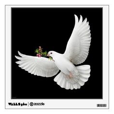 a white bird flying through the air with its wings spread out and flowers in it's beak