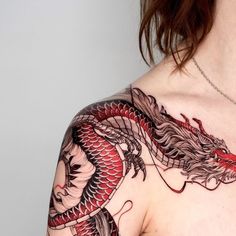 a woman with a dragon tattoo on her chest