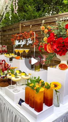 a table topped with lots of drinks and desserts