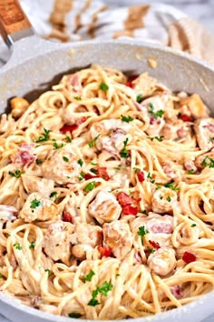 a skillet filled with pasta and chicken