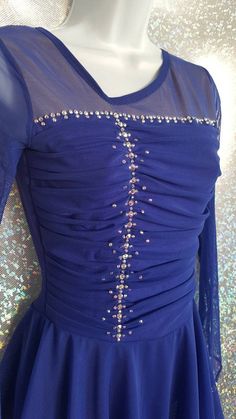 a blue dress with sequins on it