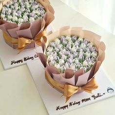 two cakes decorated with flowers and ribbons on top of each other