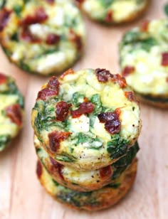 mini frittatas stacked on top of each other with bacon and spinach