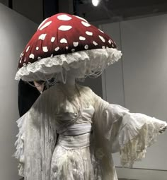 a woman is dressed up as a mushroom