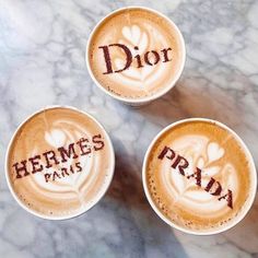 three coffee cups with the word dior written in them on a marble counter top