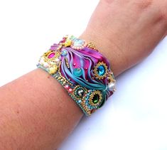 a woman's arm with a colorful bracelet on it