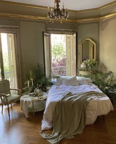 a large bed sitting in the middle of a bedroom next to two tables and chairs