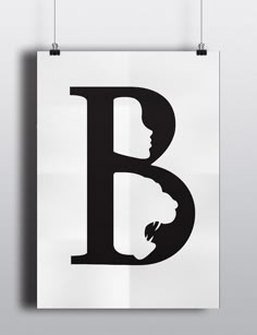 a black and white poster with the letter b in it's center, hanging on a wall