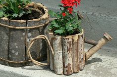 two wooden planters with red flowers in them