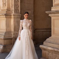 a woman in a wedding dress standing outside