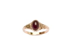 Check out this darling garnet cab, set into an etched rosy gold 10k band. This handsome ring features a swirling design that arcs all along a tapered band. The center stone features a deep merlot garnet. There is an inscription on the inside of the ring that is hard to make out but is likely a commemorative dedication of some kind. The kind of quintessential Victorian ring everyone is on the hunt for- a classic!. Classic Oval Engraved Ruby Ring, Elegant Oval Ruby Ring With Intaglio, Elegant Round Ruby Ring With Intaglio Detail, Elegant Round Ruby Intaglio Ring, Heirloom Engraved Ruby Ring For Formal Occasions, Oval Engraved Ruby Ring, Oval Ruby Jewelry With Engraving, Oval Ruby Jewelry Engraved, Oval Ruby Ring Engraved