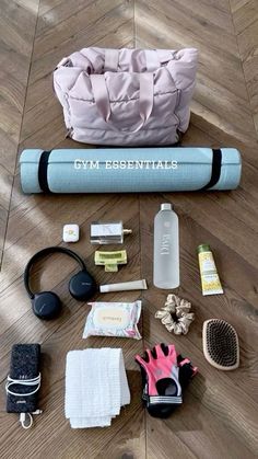 an assortment of personal care items laid out on a wooden floor with the words gym essentials