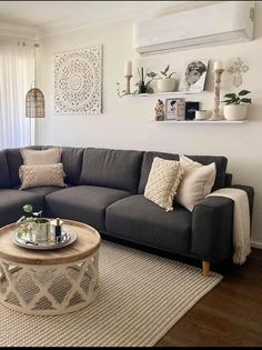 a living room with a gray couch and coffee table in front of a large window