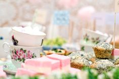 a table topped with lots of cupcakes and muffins next to each other