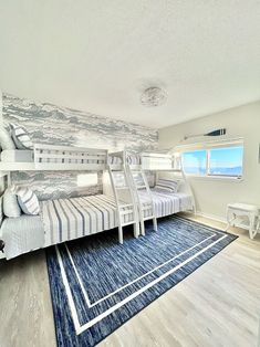 a room with bunk beds and rugs on the floor