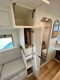 the interior of an rv with its door open and storage area in place for items to be stored