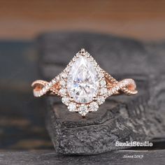 an engagement ring with a pear shaped diamond in the center