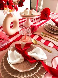 the table is set for valentine's day with red and white decor