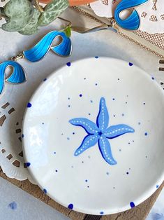 a blue and white starfish dish sitting on top of a doily