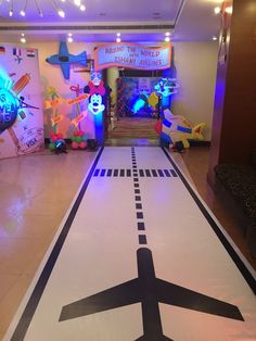 an air plane painted on the floor in front of a children's play area