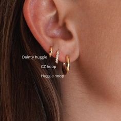 Elevate your ear game with this Huggies Earrings Set 💫! Featuring CZ ear hoops, dainty cartilage climbers, perfect for multiple piercings. This stackable set is ideal for mixing and matching with your favorite pieces--a perfect gift for your bestie. ✨ Gold huggies and climber studs bring sparkle and style to any look. Stack, shine, and stand out! 🌟 Refunds/Returns: You have 14 days after receiving the product to get all of your money back, no questions asked. Shipping & Processing: 1-3 day pro Elegant Multiple Ear Piercings, Three Earring Stack, Earring Stacks, Gift For Bestie, Earring Stack, Multiple Ear Piercings, Multiple Piercings, Dainty Hoop Earrings, Ear Stack