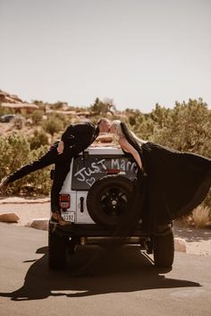 a man and woman kissing in the back of a truck