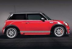 a red mini cooper parked in a dark room