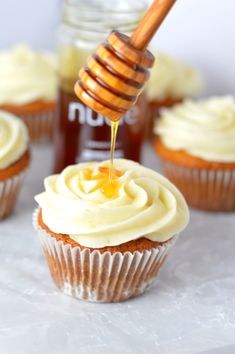 cupcakes with frosting and honey being drizzled