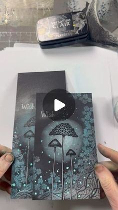 someone is holding up a card with an image of mushrooms in the forest on it