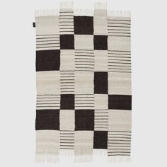 a black and white checkered rug with fringes