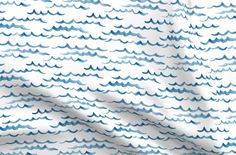 a white and blue wave pattern on fabric