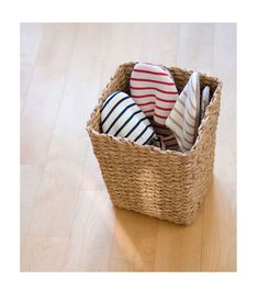 a wicker basket filled with assorted items on top of a wooden floor