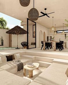 a living room filled with lots of furniture next to a wall mounted mirror and ceiling fan