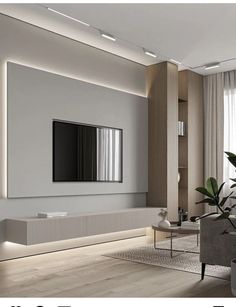 a modern living room with white walls and wood flooring, large mirror on the wall