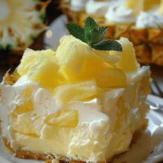 there is a piece of cake on the plate with pineapples and whipped cream