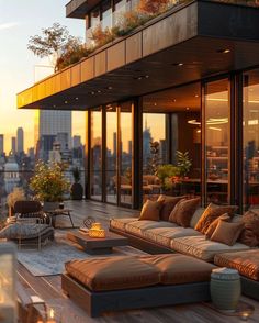 an outdoor living area with couches, tables and fire pit in the foreground