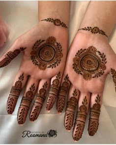 two hands with henna designs on them