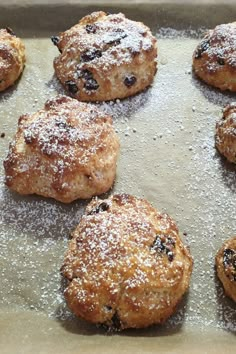 some blueberry cookies are sitting on a baking sheet and sprinkled with powdered sugar