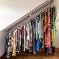 a bunch of shirts hanging on a rail