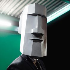 a man wearing a paper mask and suit