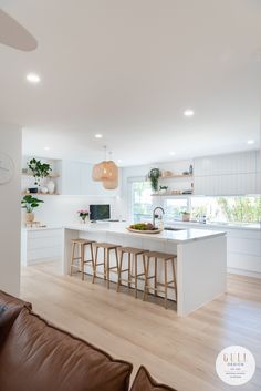 an open kitchen and living room with white walls