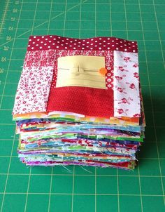 a pile of fabric sitting on top of a green cutting board next to a ruler