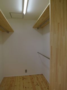 an empty room with wooden floors and white walls